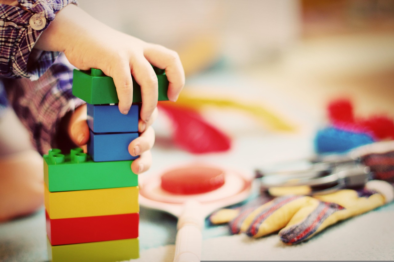 A toddler playing with a wooden shape sorter