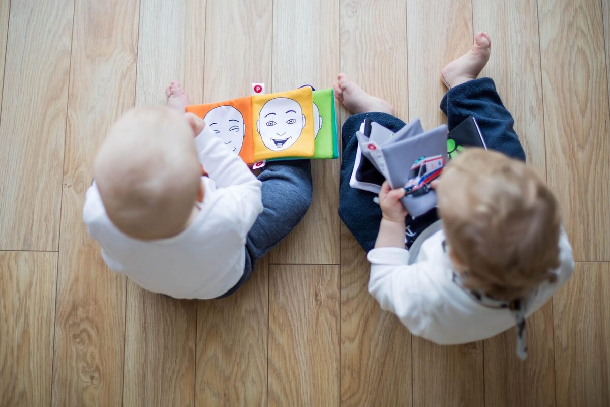 Children playing with wooden toys on a floor